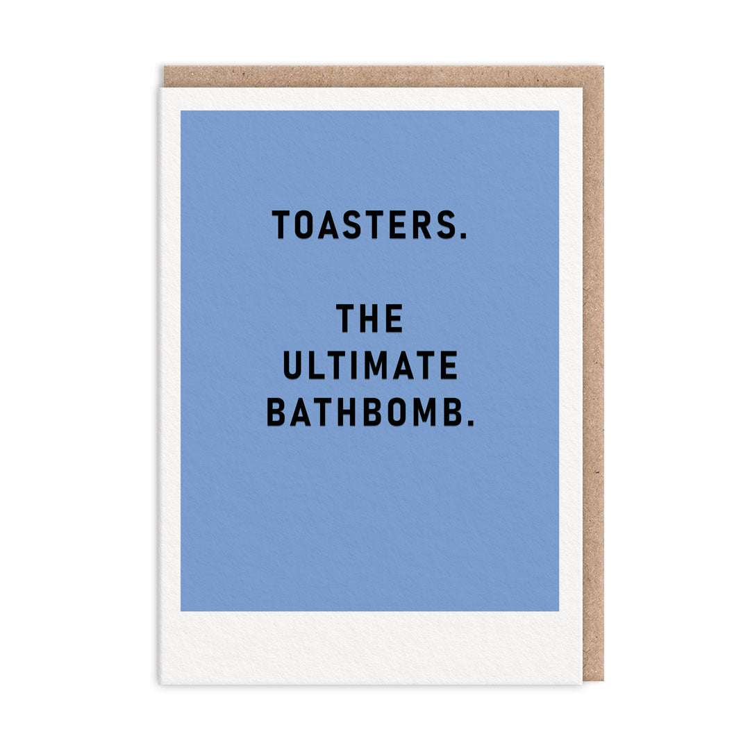 Blue greeting card with black foil text that reads "Toasters. The Ultimate Bathbomb"