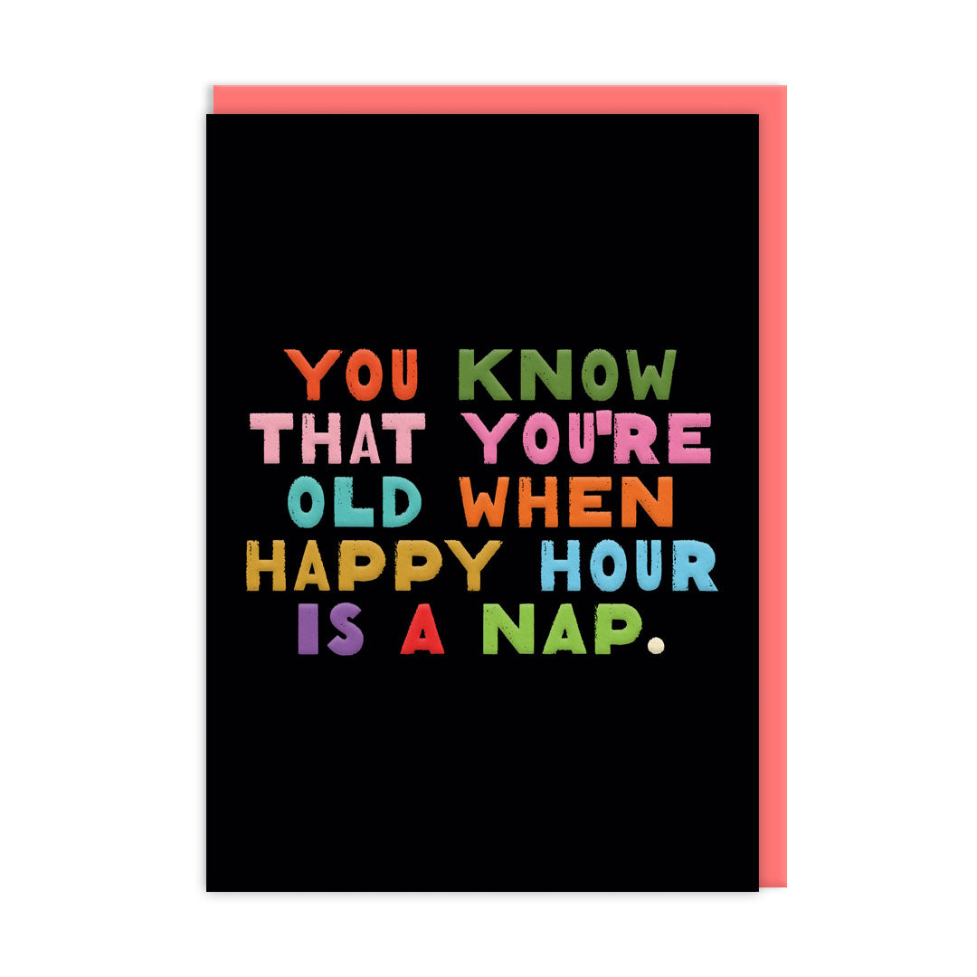 Black Birthday Card with multi coloured text that reads "You Know That You're Old When Happy Hour Is A Nap" and accompanying Coral envelope