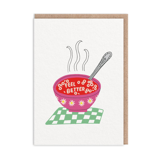 Get Well Soon card by Hartland. Features an illustration of a bowl of soup with croutons spelling out Feel Better