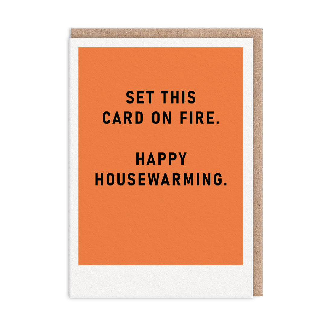Orange new home card with black foil text that reads "Set This Card On Fire. Happy Housewarming"