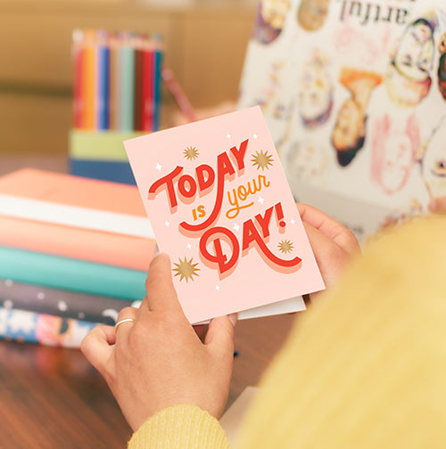 person holding a today is your day greeting card