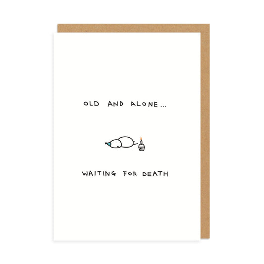 White birthday card with a basic sketch of a person lying face down and a cupcake with a single candle. Text Reads Old and Alone Waiting For Death