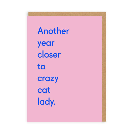 Pink birthday card with blue quote saying 'Another Year Closer to Crazy Cat Lady'
